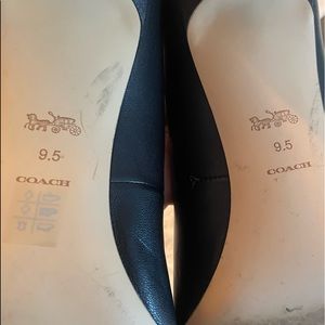A Like New with Box Coach black high heel with gold Coach emblem. Worn in store